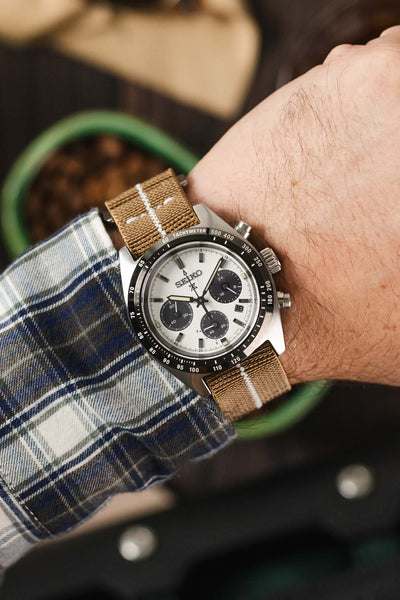 Seiko Prospex Chronograph watch on a desert sand one-piece watch strap with white centerline.